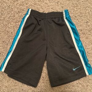Grey Nike shorts with blue and white stripes down the side. Size 4